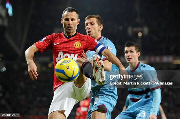 West Ham United's Gary O'Neil and Manchester United's Ryan Giggs battle for the ball during the FA Cup Third Round Replay at Old Trafford, Manchester.