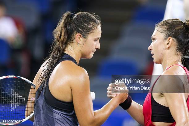 Daria Kasatkina of Russia shakes hands with Simona Halep of Romania aftering winning the second round Ladies Singles match on Day 3 of 2017 Dongfeng...