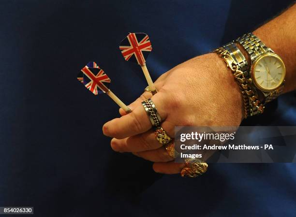 Detailed view of England's Tony O'Shea holding two of his Union Flag flighted darts