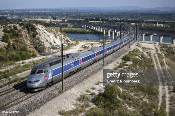 Duplex high-speed train, operated by Societe Nationale des Chemins de Fer and manufactured by Alstom SA, crosses the River Rhone outside Avignon as...