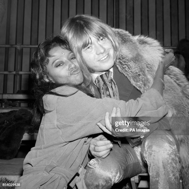 Donyale Luna, who is one of the world's highest paid American models, hugs musician Brian Jones at rehearsal in Wembley, London, of the TV...