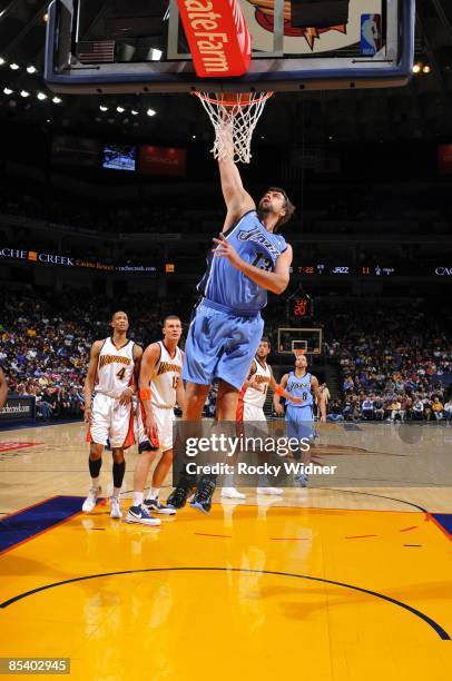 Mehmet Okur of the Utah Jazz dunks during the game against the Golden State Warriors at Oracle Arena on March 1, 2009 in Oakland, California. The...