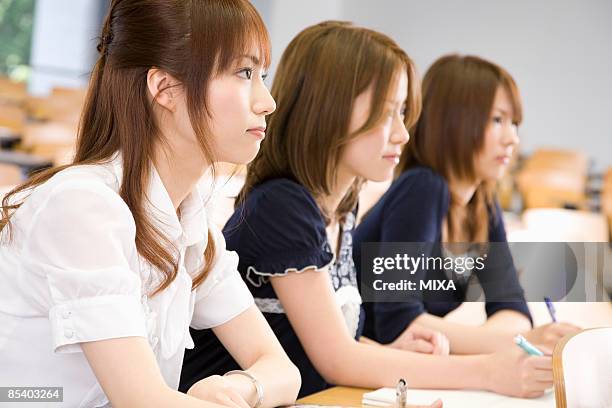 three young women studying at college - university of tokyo 個照片及圖片檔