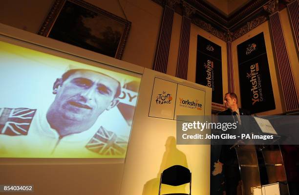 Director of the Tour de France Christian Prudhomme looks at a picture of Great Britain's Tommy Simpson, from Doncaster, who died of a drugs overdose...