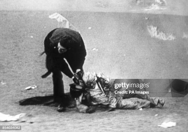 Screen shot from ITN News showing a policeman helping a victim of the fire that swept through the main stand at Bradford City's football ground. The...