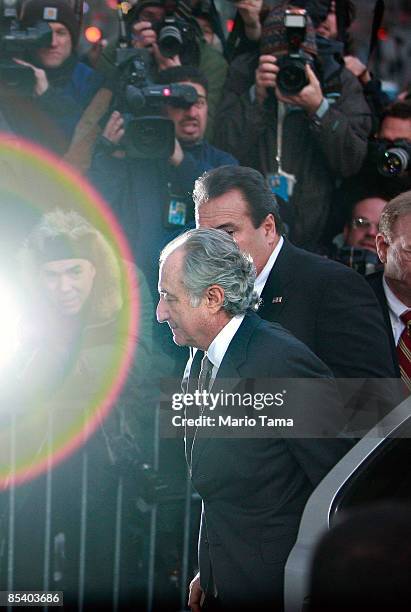 Accused $50 billion Ponzi schemer financier Bernard Madoff enters a Manhattan Federal courthouse past a strobe flashed by the media throng March 12,...