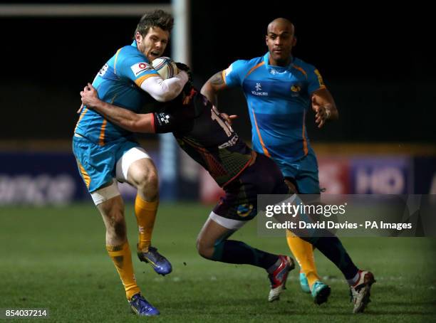 Wasps Elliot Daly is tackled by Adam Hughes of the Dragons during the Amlin Challenge Cup at Rodney Parade, Newport.