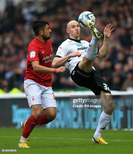 Derby's Conor Sammon and Nottingham Forest's Gonzalo Jara battle for the ball during the npower Championship match at Pride Park, Derby.