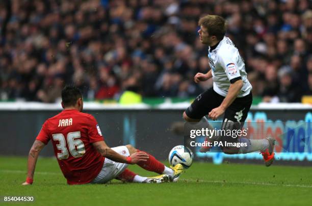 Derby's Jamie Ward and Nottingham Forest's Gonzalo Jara battle for the ball during the npower Championship match at Pride Park, Derby.
