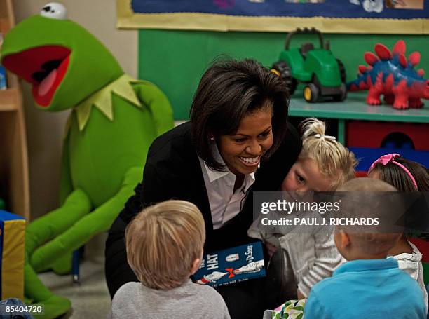 First Lady Michelle Obama reads Dr. Seuss's "Cat In The Hat" to 3 and 5-year-old children at the Prager Child Development Center for military...