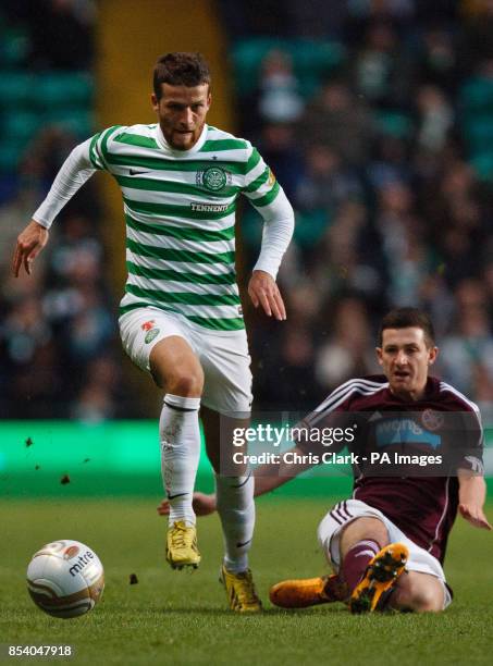 Celtic's Adam Matthews breaks the tackle from Hearts' Jason Holt during the Clydesdale Bank Scottish Premier League match at Celtic Park, Glasgow.