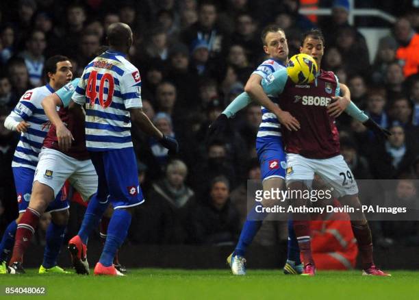 West Ham's Marouane Chamakh appears to be held back by QPR's Clint Hill during the Barclays Premier League match at Upton Park, London.
