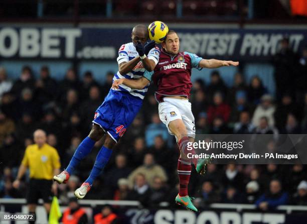 West Ham's Joe Cole and QPR's Stephane Mbia compete for a header during the Barclays Premier League match at Upton Park, London.