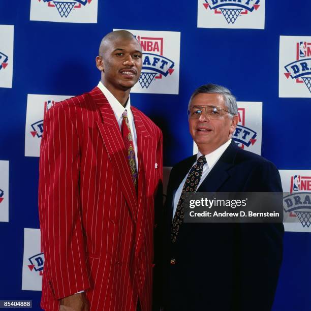 Jalen Rose, selected thirteenth overall by the Denver Nuggets in the 1994 NBA Draft poses with David Stern on June 29, 1994 in Idianapolis, Indiana....