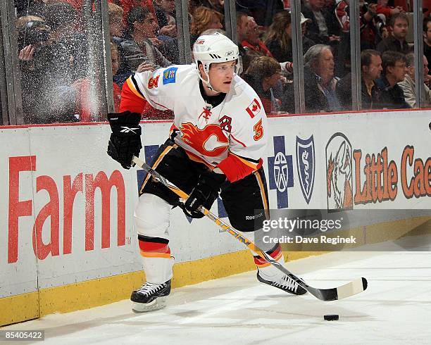 Dion Phaneuf of the Calgary Flames plays the puck behind the net during a NHL game against the Detroit Red Wings on March 12, 2009 at Joe Louis Arena...