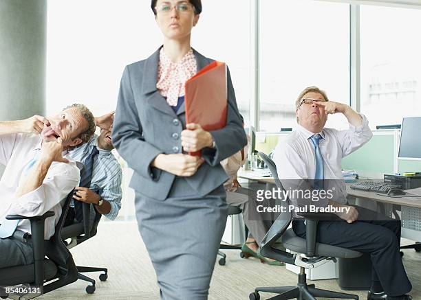 businesspeople making face at boss in office - taunts stock pictures, royalty-free photos & images