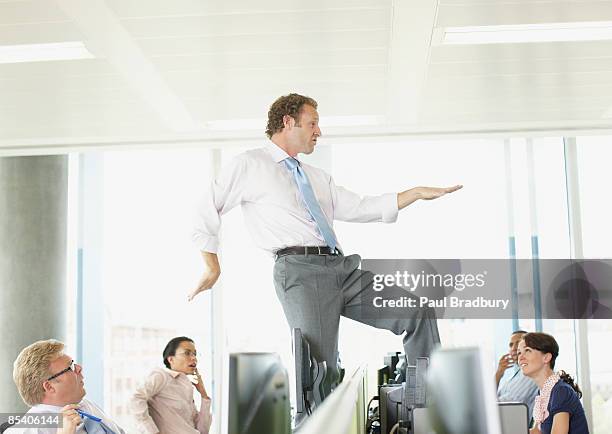 businessman dancing on cubicle desk - arrogant stockfoto's en -beelden