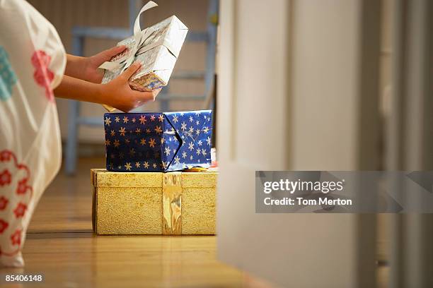 child looking at christmas gift - suspicious package stock pictures, royalty-free photos & images