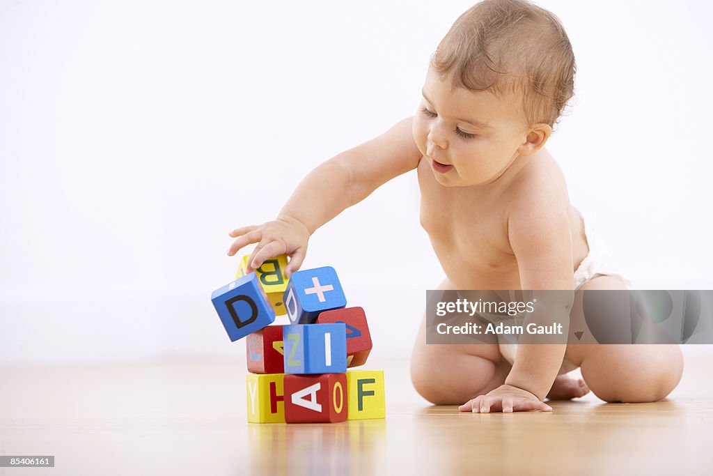 Baby playing with alphabet blocks