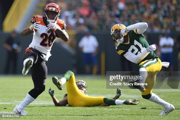 Joe Mixon of the Cincinnati Bengals avoids a tackle by Ha Ha Clinton-Dix of the Green Bay Packers during a game at Lambeau Field on September 24,...