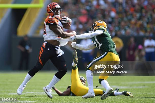 Joe Mixon of the Cincinnati Bengals avoids a tackle by Ha Ha Clinton-Dix of the Green Bay Packers during a game at Lambeau Field on September 24,...