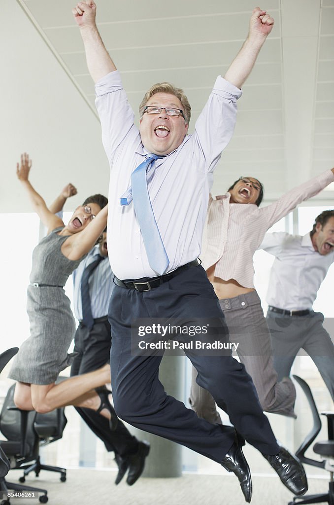Businesspeople cheering in office