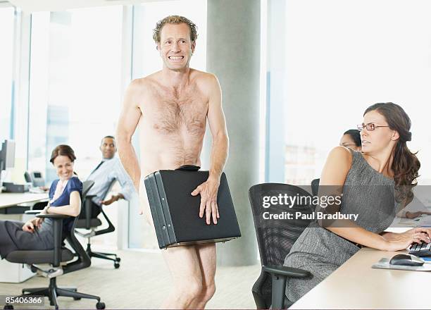 naked businessman with briefcase in office - verlegen stockfoto's en -beelden