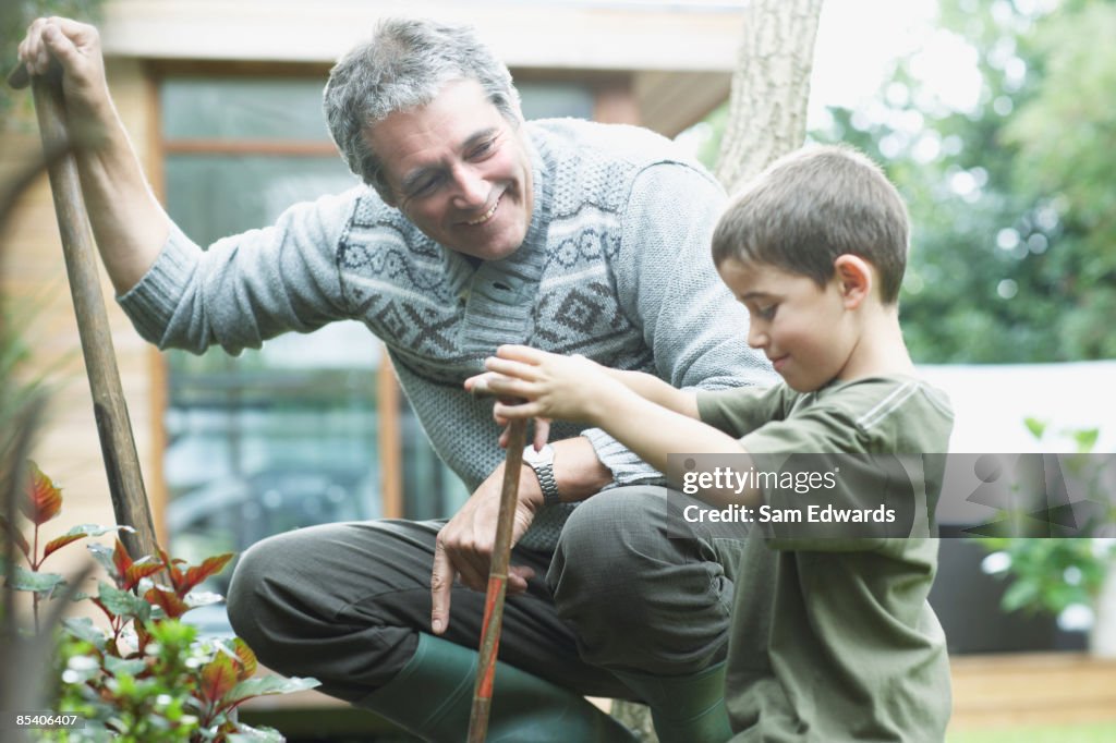 Grandfather and grandson gardening