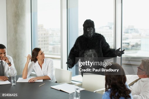 Gorilla and businesspeople having meeting in conference room Gorilla and businesspeople having meeting in conference room