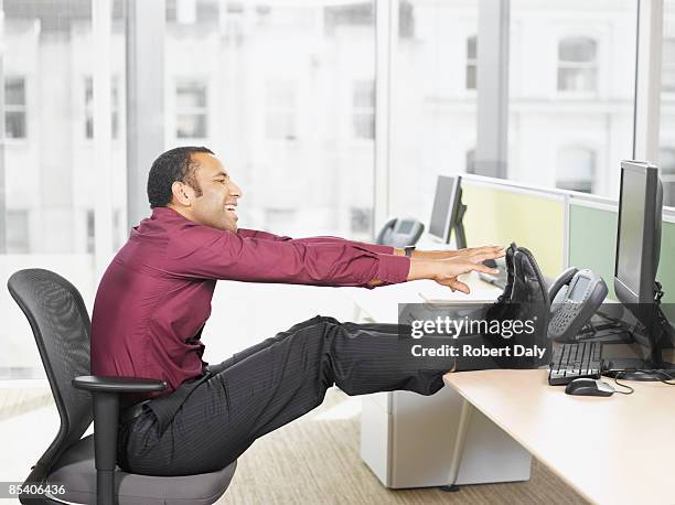 businessman stretching at desk - man feet up on desk stock pictures, royalty-free photos & images