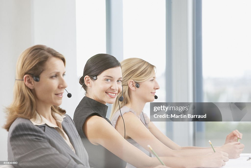 Businesswomen talking on headsets