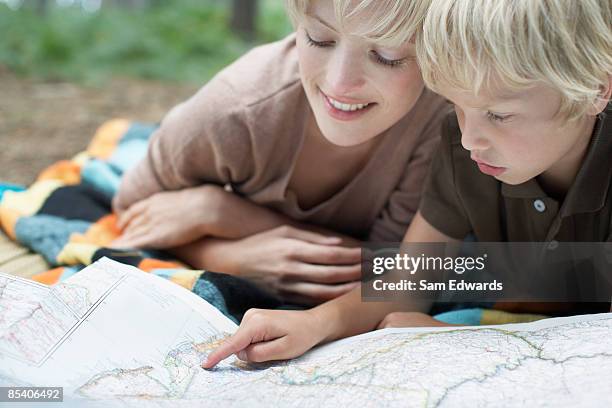 mother and son looking at map - innocence project stock pictures, royalty-free photos & images