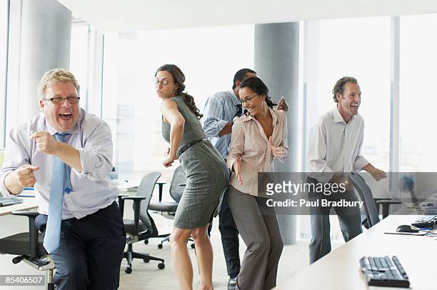 businesspeople dancing in office - celebration of dance stock pictures, royalty-free photos & images