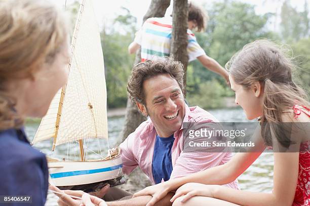 family having fun near lake - interested listener stock pictures, royalty-free photos & images