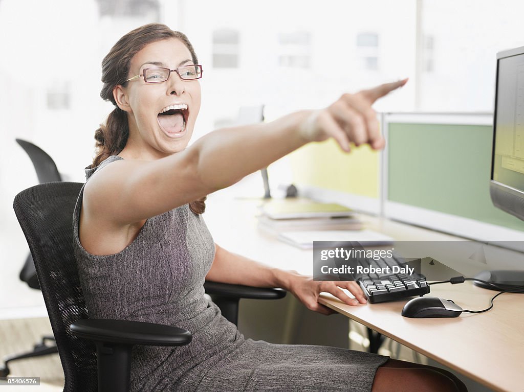 Businesswoman pointing and shouting