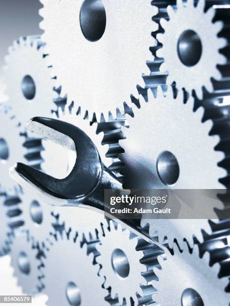 cogs with wrench in middle - sabotage stock pictures, royalty-free photos & images