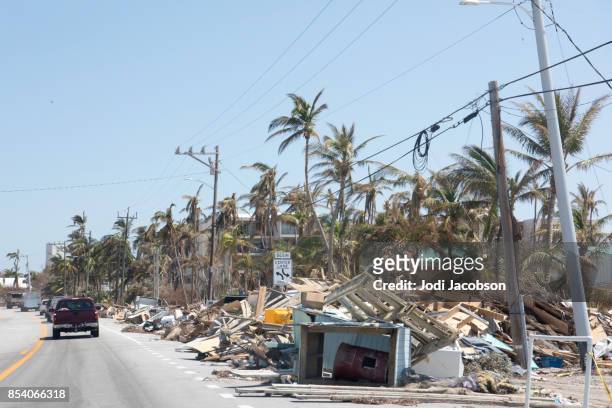 aftermath of hurricane in florida keys leaves piles of trash and debris to be cleaned up - damaged stock pictures, royalty-free photos & images