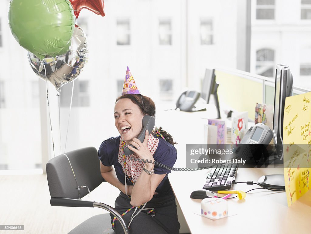 Businesswoman having birthday party at desk