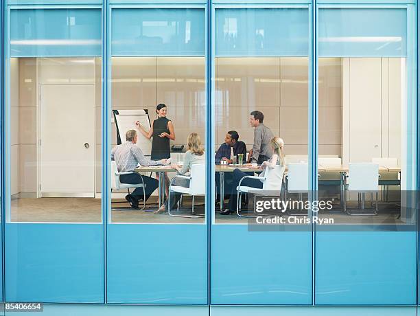 businesspeople having meeting in conference room - blank flipchart stock pictures, royalty-free photos & images