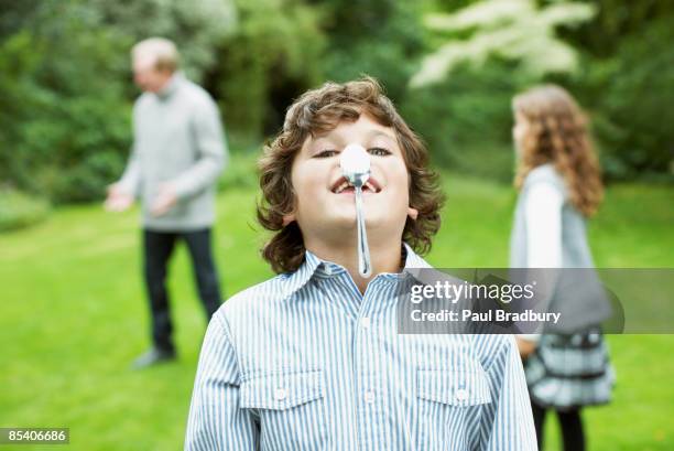 boy balancing spoon on nose - girl hold nose stock pictures, royalty-free photos & images