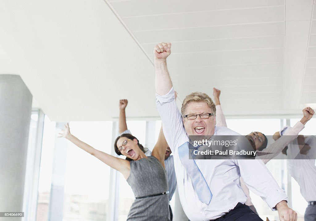 Businesspeople dancing in office