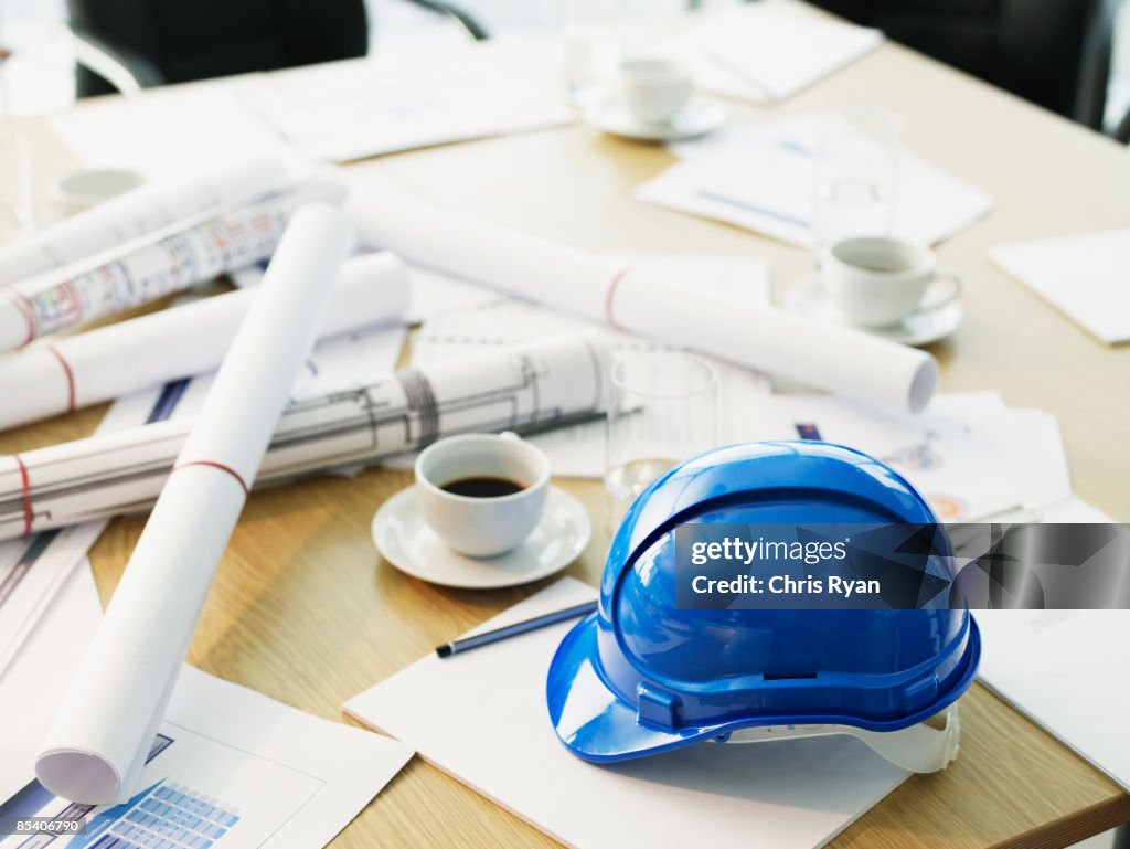 Table with hard-hat and blueprints