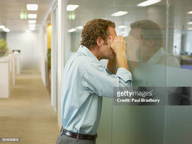 businessman peering into conference room - suspicion stock pictures, royalty-free photos & images