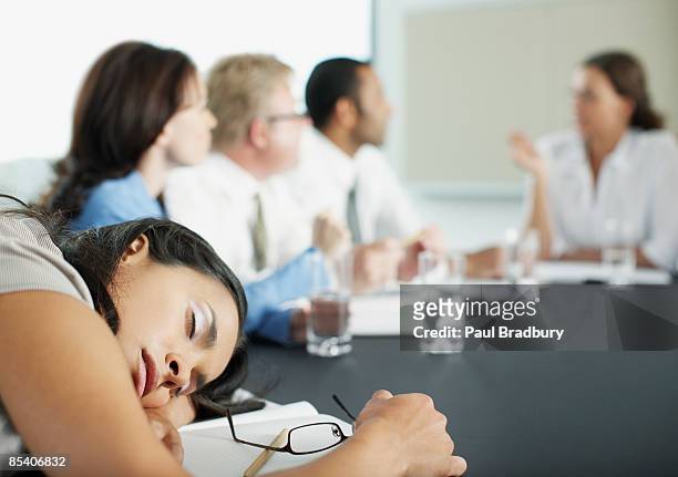 businesswoman sleeping in conference room during meeting - boredom bildbanksfoton och bilder