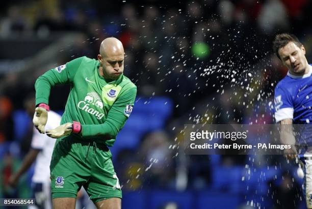 Everton's Tim Howard evades snowballs being thrown from the crowd during the FA Cup Fourth Round match at the Reebok Stadium, Bolton.