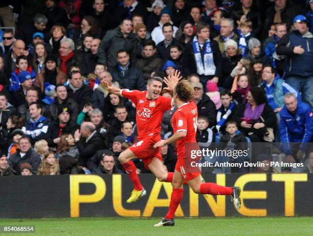 Dons' Ryan Lowe celebrates scoring the second goal during the FA Cup Fourth Round match at Loftus Road, London.