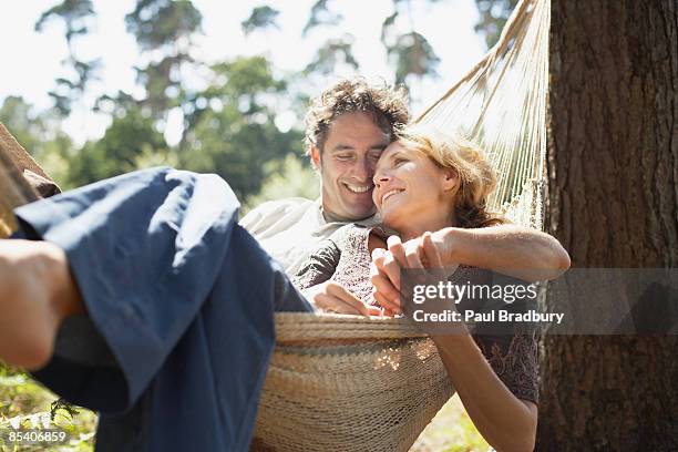 couple sitting in hammock - fall out of love stockfoto's en -beelden