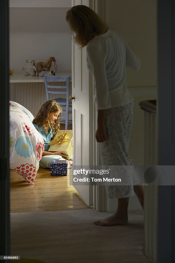 Girl looking at Christmas gift