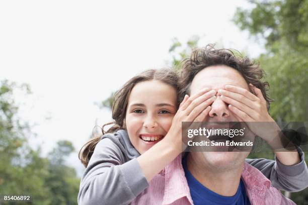 daughter covering fathers eyes - hands covering eyes 個照片及圖片檔