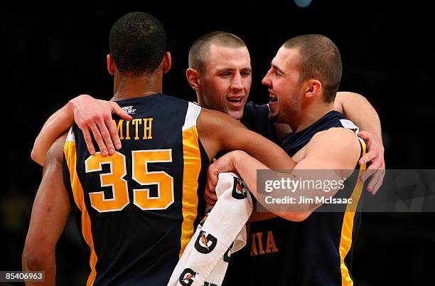 Wellington Smith, Alex Ruoff and Cam Thoroughman of the West Virginia Mountaineers celebrate after their win against the Pittsburgh Panthers during...